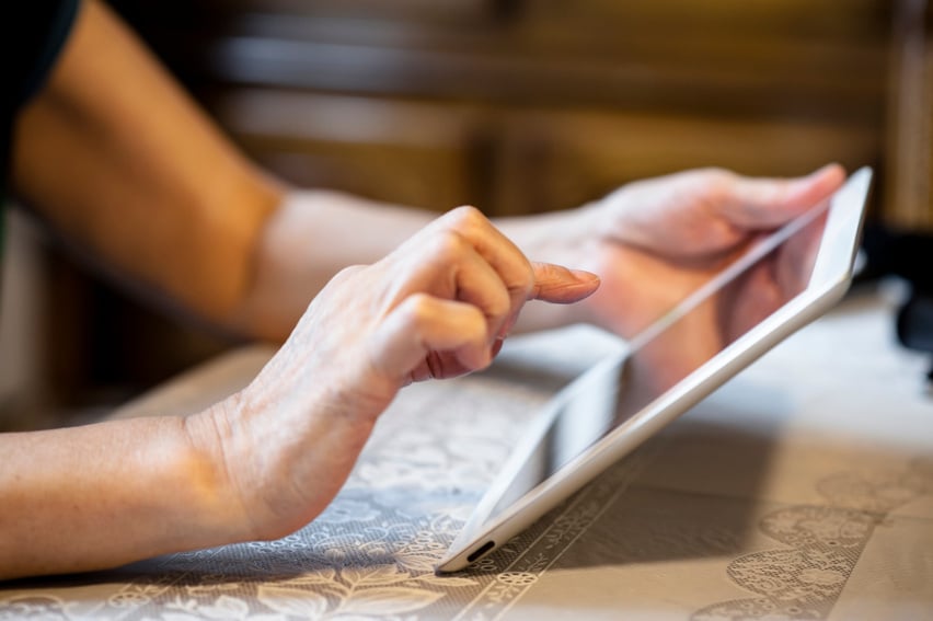 Senior using tablet computer